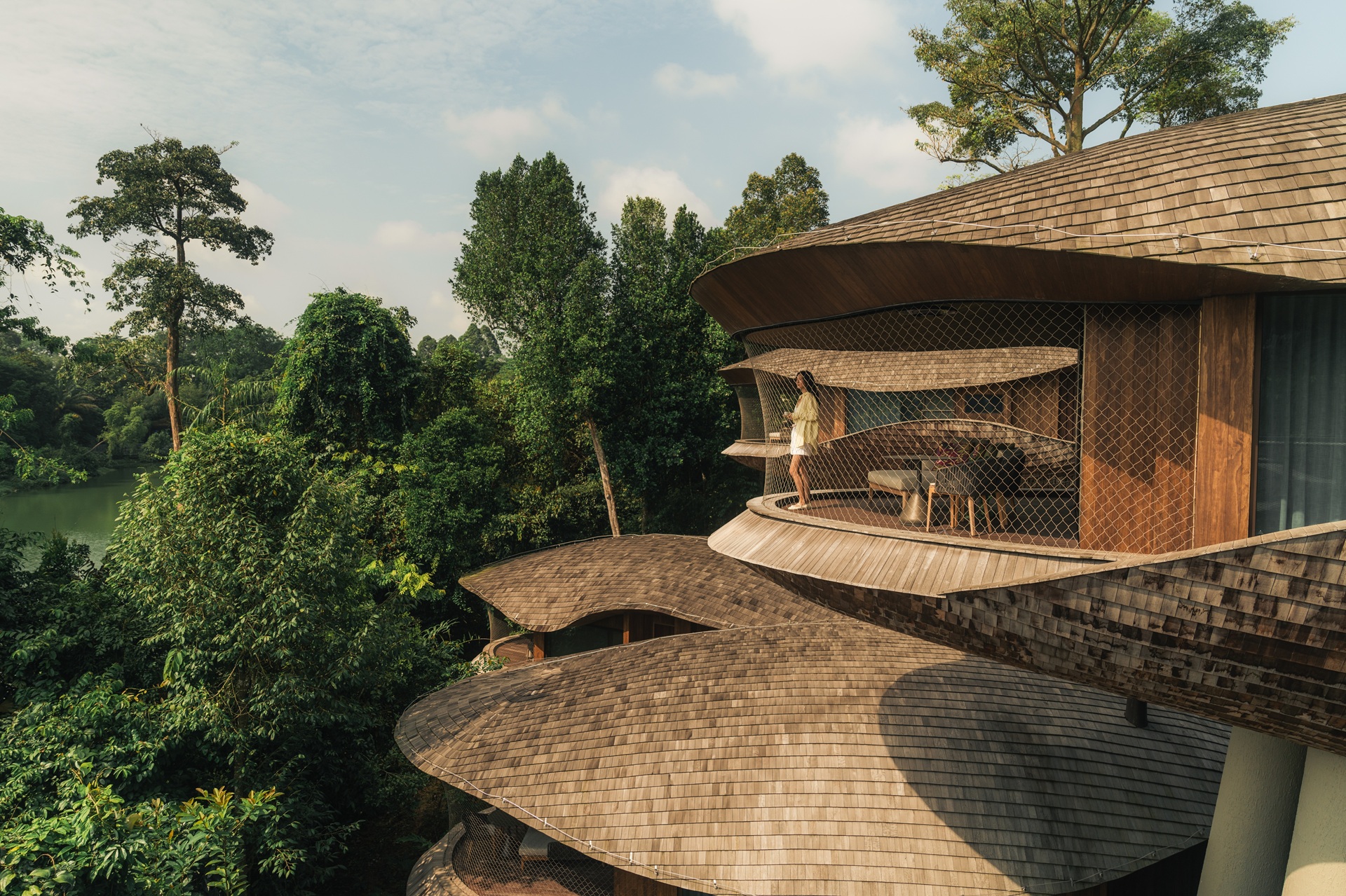 Indulge in the comfort of our Mandai Rainforest Treehouse, featuring luxurious rooms with a king-size bed and a private patio.